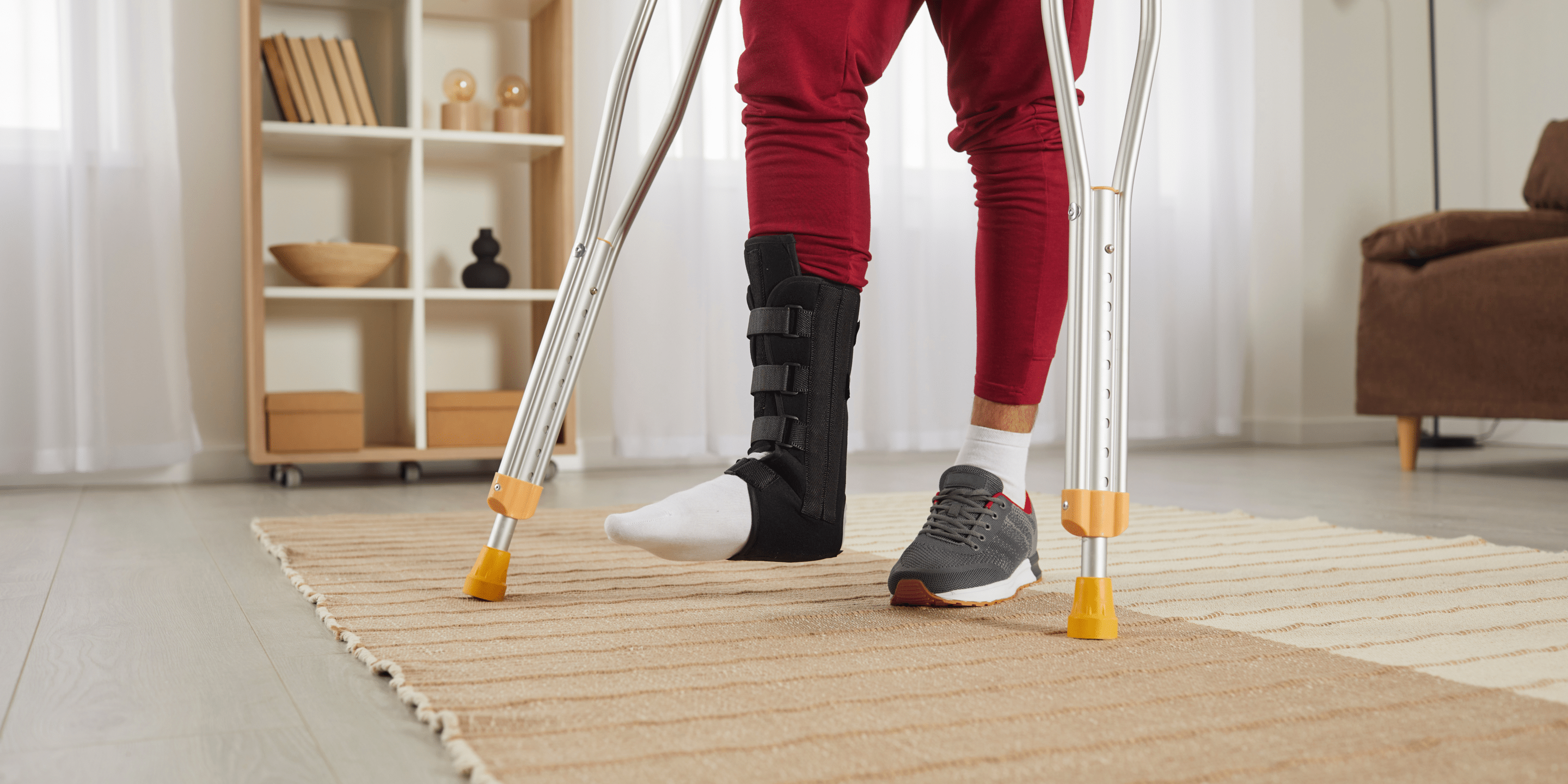 Unwell man with broken leg in plastered splint walk on crutches at home. Unhealthy injured male make first steps have rehabilitation after foot injury or trauma. Health problem, rehab concept.